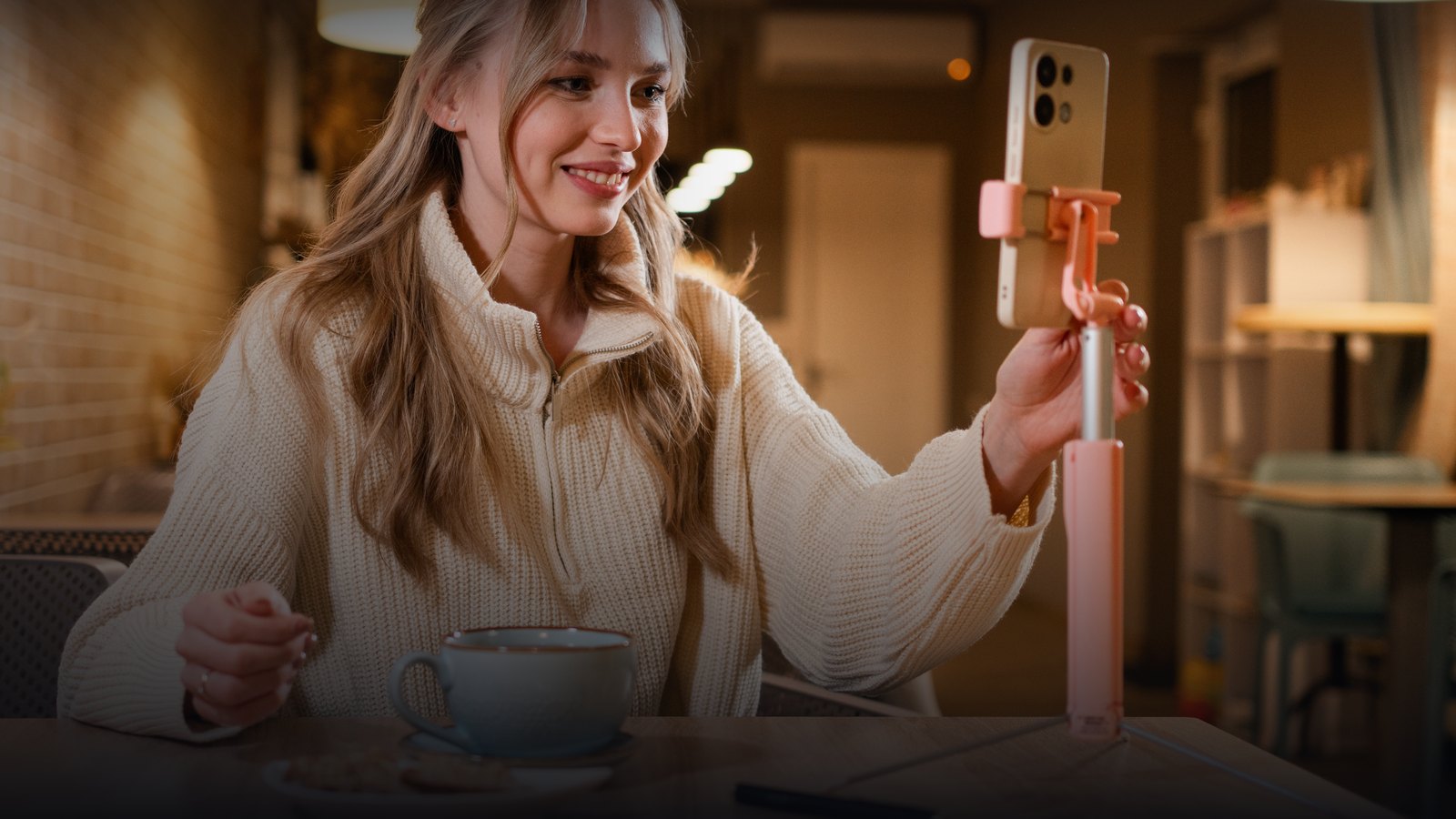 Creator recording a UGC video with a phone and ring light in a cafe for Jupiter brands